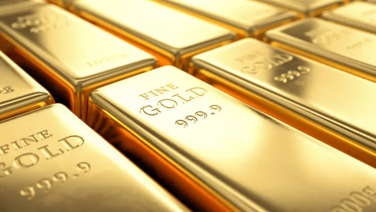 Close-up rows of fine gold bars stamped 999.9